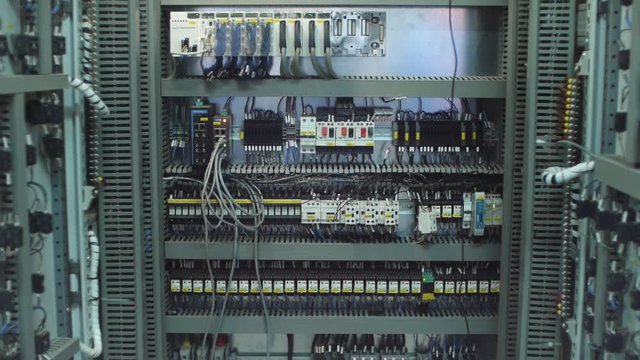 Wires in a box of distribution of an electricity. Clip. Electrical panel with fuses and contactors. Several contactors arranged in a row in an electrical closet