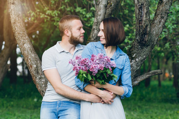 Couple in love have a rest in the summer Apple orchard