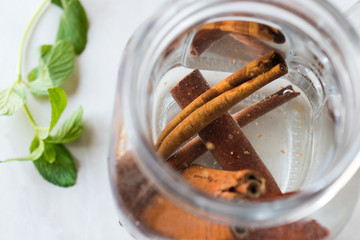Fototapeta na wymiar Water with Cinnamon Sticks in Mason Jar.