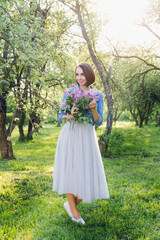 Girl posing with a bouquet of lilac