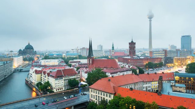 Berlin, Germany. Illuminated landmarks in Berlin, Germany in the morning. Time-lapse of colorful cloudy sky at sunrise during the rain