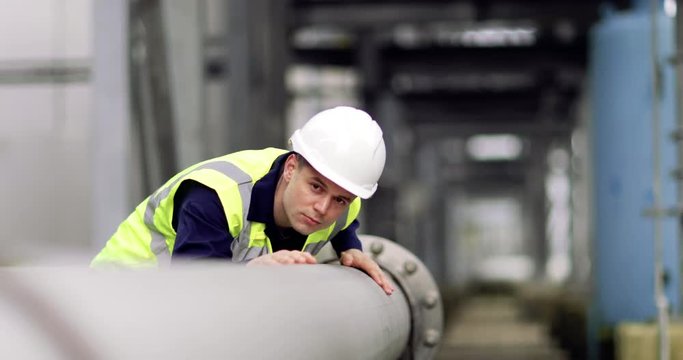 Industrial worker checking pipeline