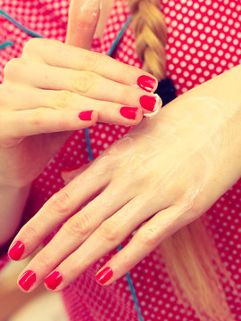 Woman applying hand cream on hands