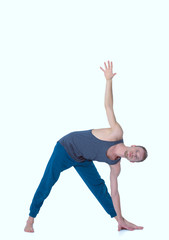 Adult man doing yoga exercise on white background