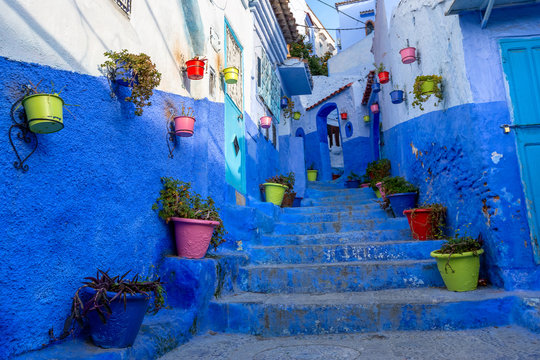 Blue street with color pots in Chefchaouen