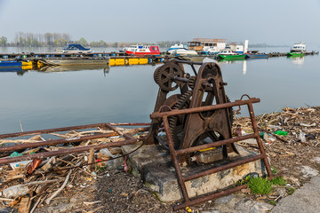 Naklejka premium Belgrade, Serbia April 07, 2018: The Danube Coast in Zemun. Ship pulling machine and what remains on the shore when the water withdraws.