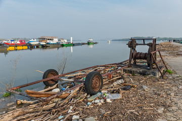 Naklejka premium Belgrade, Serbia April 07, 2018: The Danube Coast in Zemun. Ship pulling machine and what remains on the shore when the water withdraws.