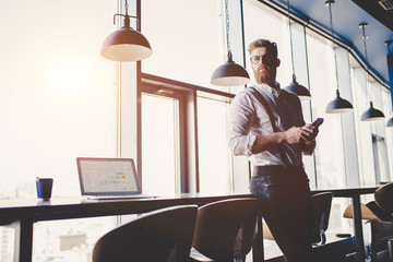 Young man is working in modern office