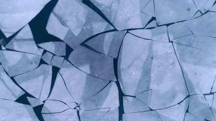 Aerial top view of cracked ice floes. Drone shot flying up over melting ice, global warming, climate change background. Beautiful winter pattern - Powered by Adobe