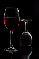 Glass with red wine on a black background