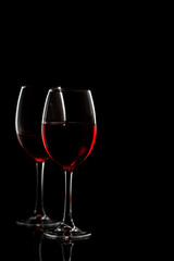 Glass with red wine on a black background