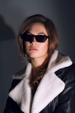 Stylish beauty portrait with glasses of a fashionable girl with makeup and hair