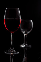 Glass with red wine on a black background