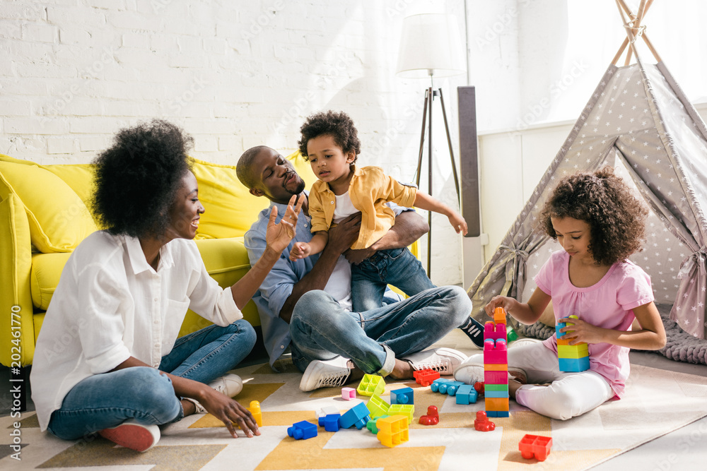 Wall mural african american family spending time together at home