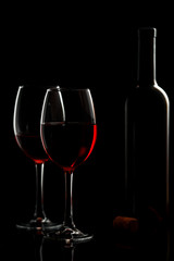 Glass with red wine on a black background