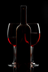 Glass with red wine on a black background