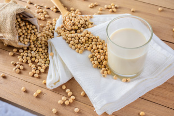 Soy milk and beans on wooden table background