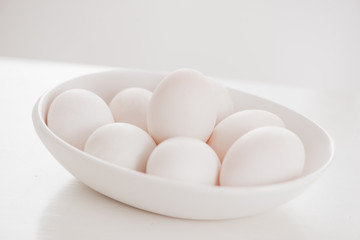 Eggs on white plate on wooden table
