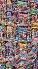 Fototapeta na wymiar Detail from a Gopuram, or entrance tower, at an ancient Hindu temple in Tamil Nadu. It was only during the last century that temple authorities began to paint the gateway carvings
