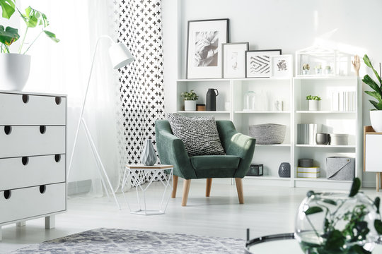 White furniture and green armchair