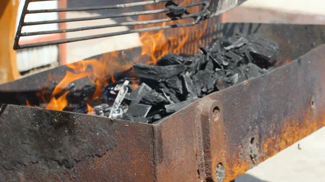Placing Coal In A Grill For Barbecue