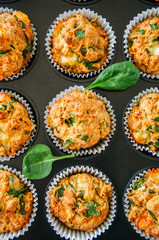 Savory potato spinach and feta muffins in a baking form. Top view.