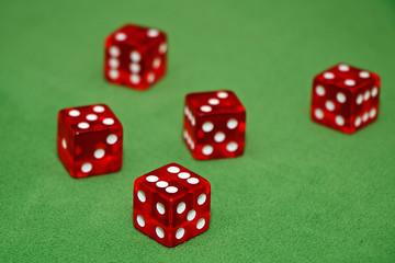 Red dices of a casino on a green table