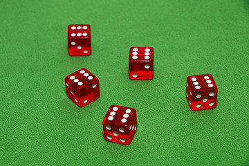 Red dices of a casino on a green table