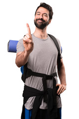Fototapeta premium Handsome backpacker counting one on white background