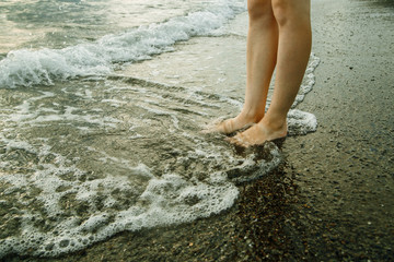 Feet in the water by the sea