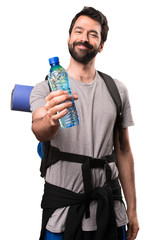 Happy Handsome backpacker with a bottle of water on white background