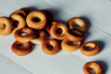 Baked bread bagels on a white surface, background.