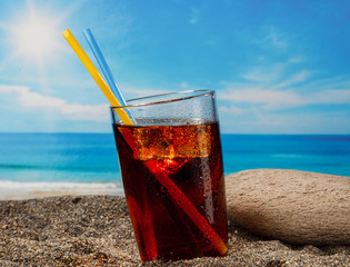 A cold drink in a glass on the beach, a delicious soft drink in the summer - 202468188