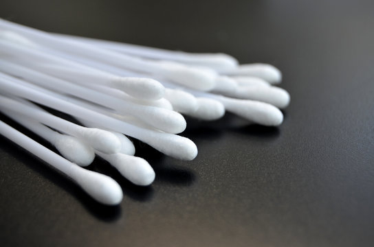 White Cotton Buds on Black Tile Surface