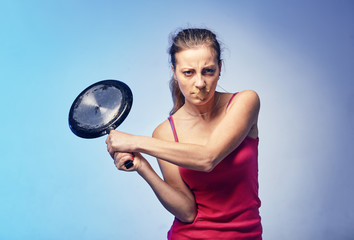 A woman with a frying pan in her arms