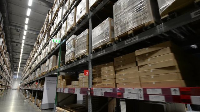 Moving between palettes with ordered goods and materials at warehouse
