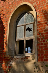 Broken classic windows in a red brick building