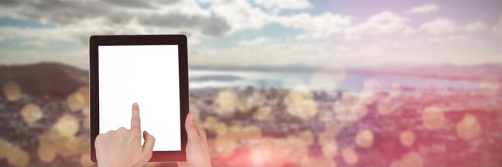 Composite image of hands touching digital tablet against white