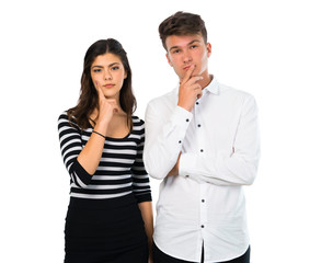 Young couple  having doubts and with confuse face expression on isolated white background