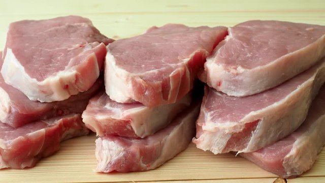Fresh raw pork slices on wooden board