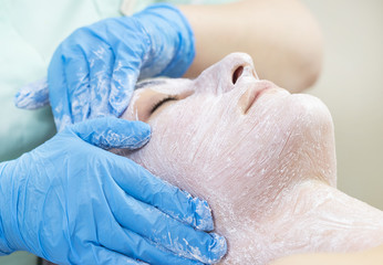 Massage and facial peels at the salon using cosmetics 