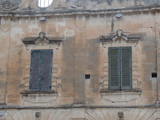 Fototapeta na wymiar Traditional Italian windows with shutters in Lecce, Puglia, Southern Italy