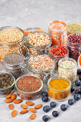 Various superfoods goji berries, quinoa, chia, hemp seeds, flax seeds, chickpeas, oats, almond, blueberries, curcuma, matcha and lantils. Vegan, vegetarian healthy eating diet organic products concept