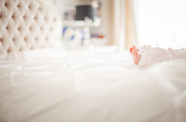 Fototapeta na wymiar Baby girl in parents bed.