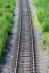 Fototapeta na wymiar Railroad and green grass. Train rails 