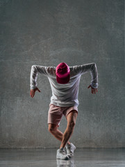 Fototapeta na wymiar Young beautiful male dancer posing in studio