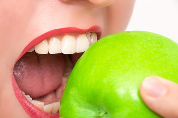 Woman bites in green apple