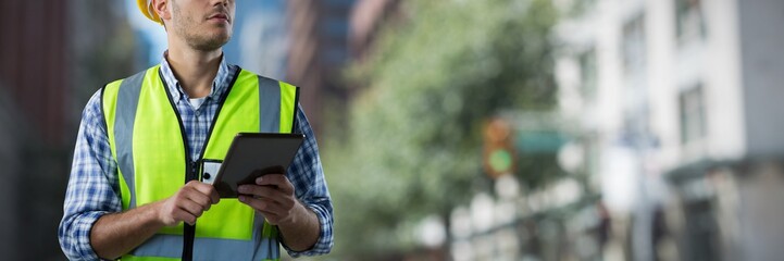 Composite image of concentrated construction worker with tablet