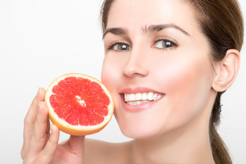 Beautiful girl with juicy grapefruit