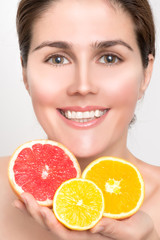 Beautiful female face with fresh fruits